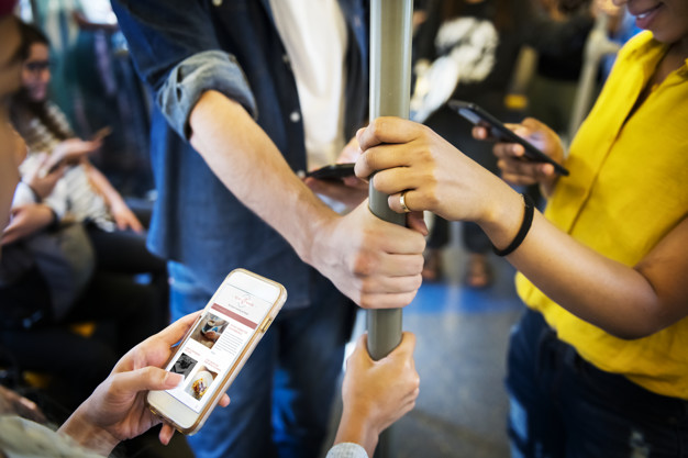 Adult-using-phones-in-metro